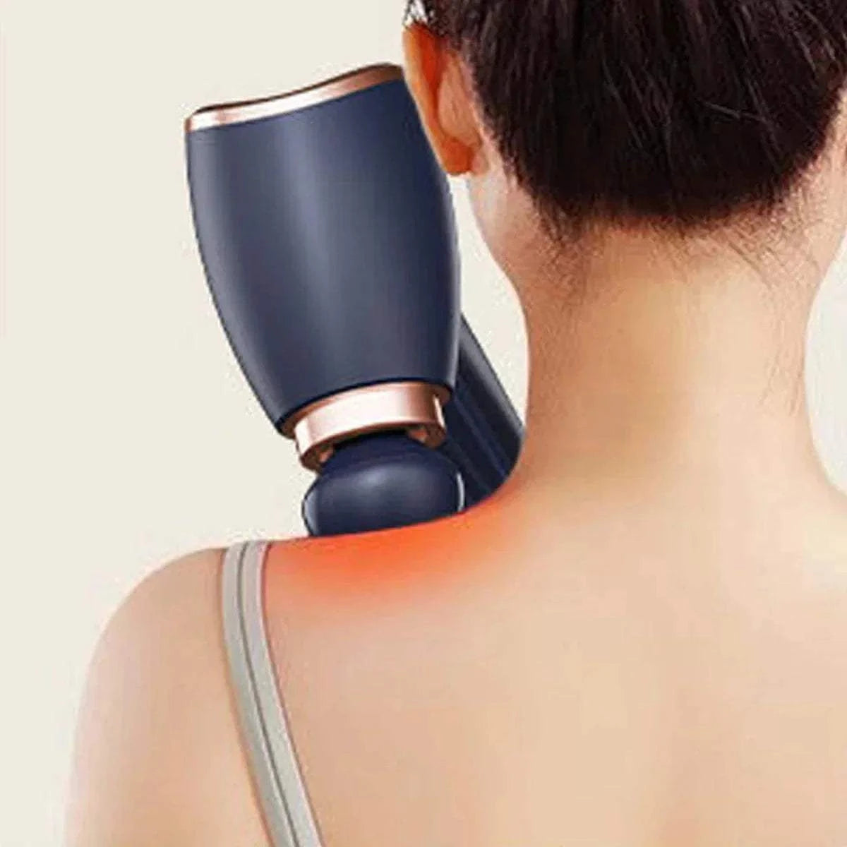 Handheld electric massage gun delivering deep tissue percussion therapy on shoulder and neck muscles