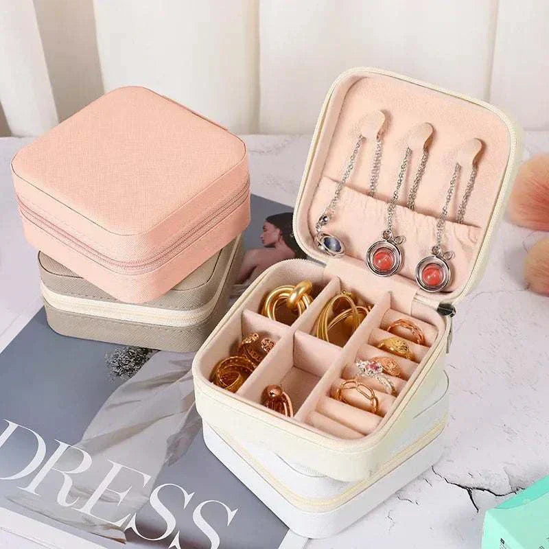 Compact portable mini jewelry storage box in soft PU leather with compartments for earrings, rings, and necklaces
