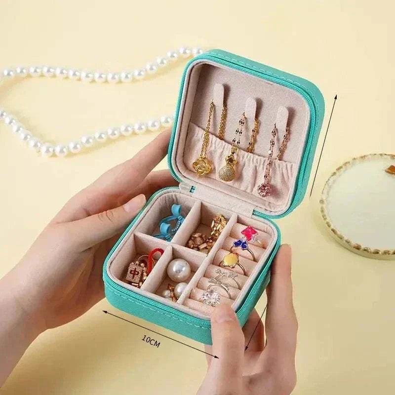 Compact turquoise mini jewelry box with multiple compartments for earrings, rings, and necklaces, made of PU leather, ideal for travel and daily use.