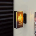 Mini Lightbox fridge magnet with glowing coffee cup design attached to refrigerator door