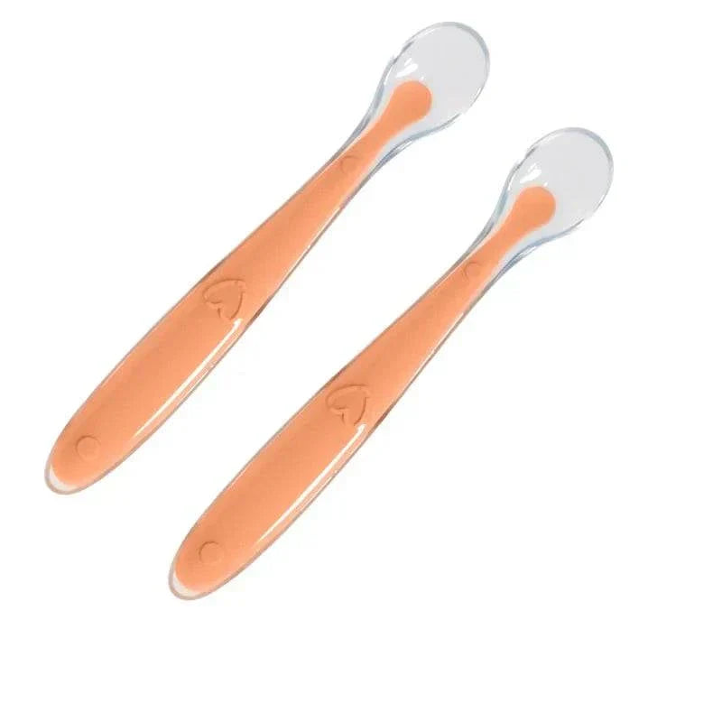 Two orange silicone spoons for baby feeding, BPA-free and safety certified