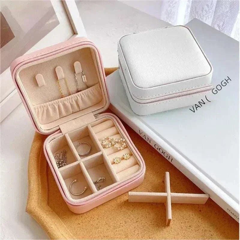 Compact pink mini jewelry box with multiple compartments for earrings, rings, and necklaces, made of PU leather, perfect for travel and home organization