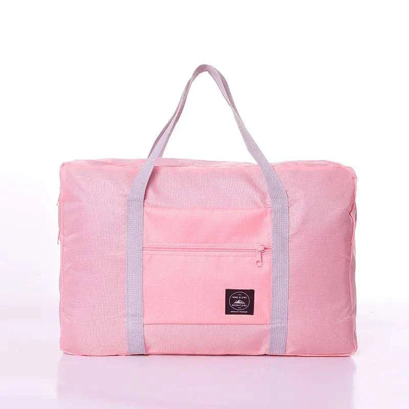 Foldable travel duffel bag for women, lightweight, durable, water-resistant, spacious, with handles and trolley sleeve, airline-friendly personal item size.