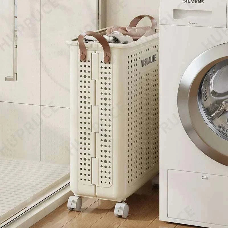 Foldable laundry organizer basket with casters and handles in cream white next to washing machine