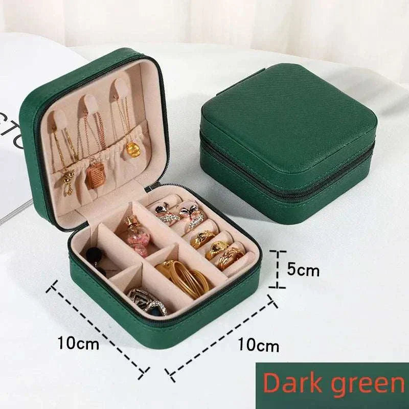 Dark green mini jewelry box with compartments for rings, earrings, and necklaces, portable travel organizer in PU leather, 10x10x5 cm compact size.