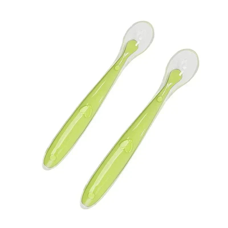 Two green silicone spoons for baby feeding BPA free safe utensils
