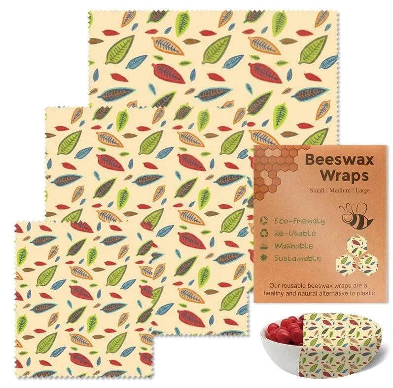 3-piece set reusable beeswax food wraps with colorful leaf pattern and eco-friendly packaging next to bowl of cherry tomatoes