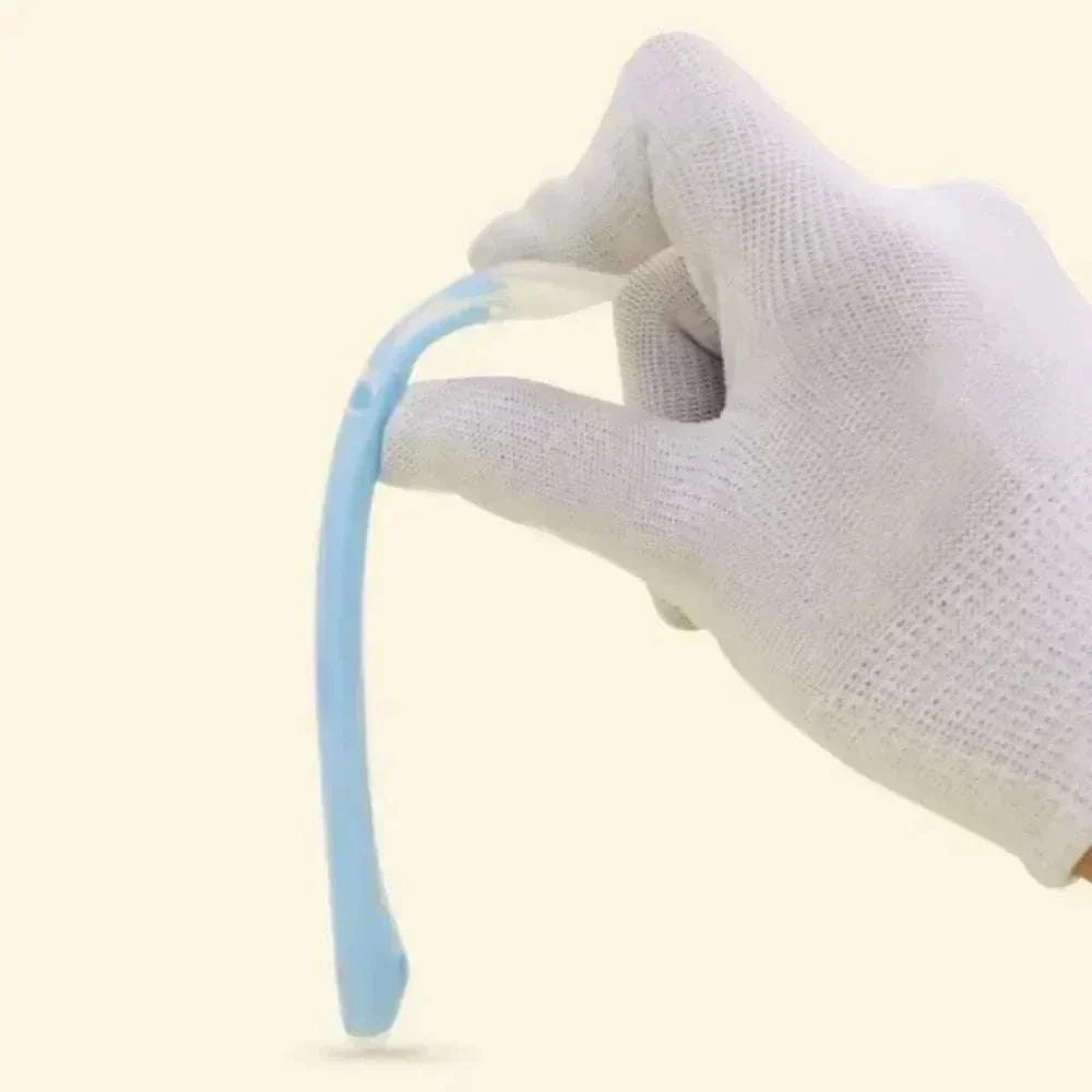 Flexible blue silicone spoon for baby feeding held by gloved hand