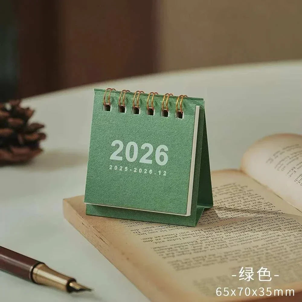 2026 mini simple desk calendar with spiral binding and minimalist design on a desktop