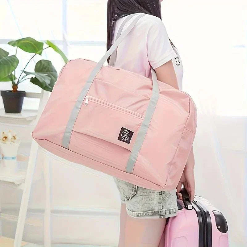 Lightweight foldable travel duffel bag in pink with large capacity and shoulder straps for women and girls Foldable Travel Duffel