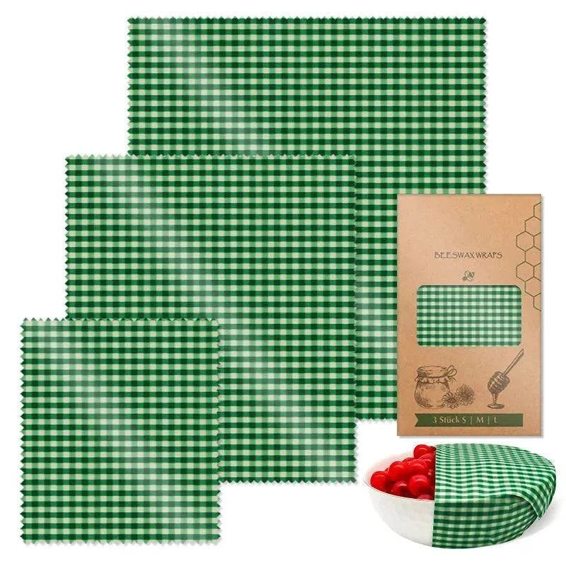 3-piece set green checkered reusable beeswax food wraps with packaging and bowl of tomatoes wrapped in wax cloth