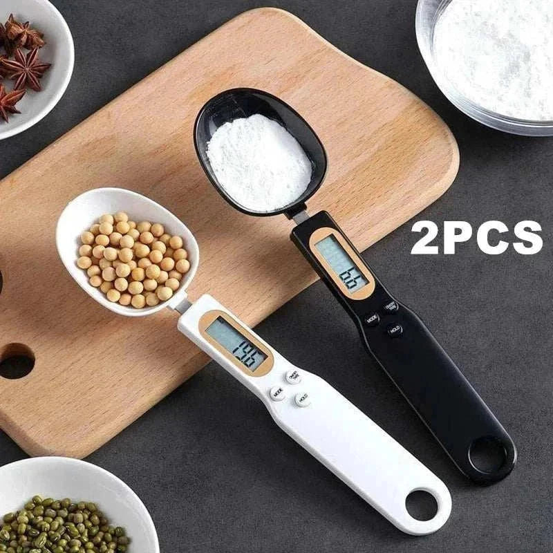 Two mini spoon scales with digital LCD display measuring flour and soybeans on a wooden cutting board. Mini Spoon Scale