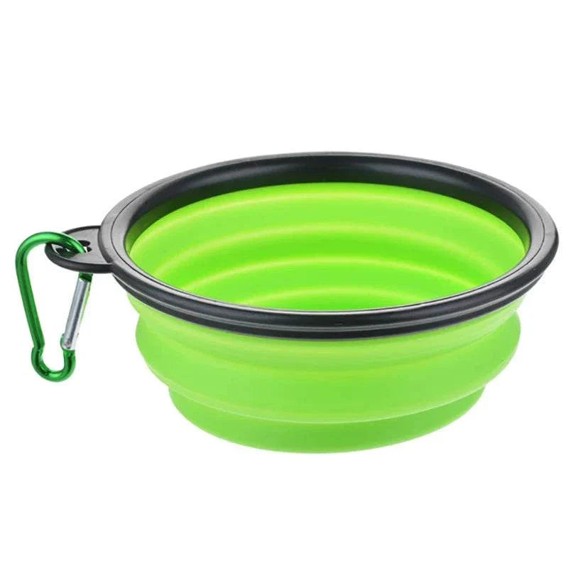 Collapsible green silicone pet dog bowl with black rim and green carabiner for travel and outdoor use